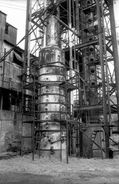 The imposing Caroni distillation column, decommissioned and rusting